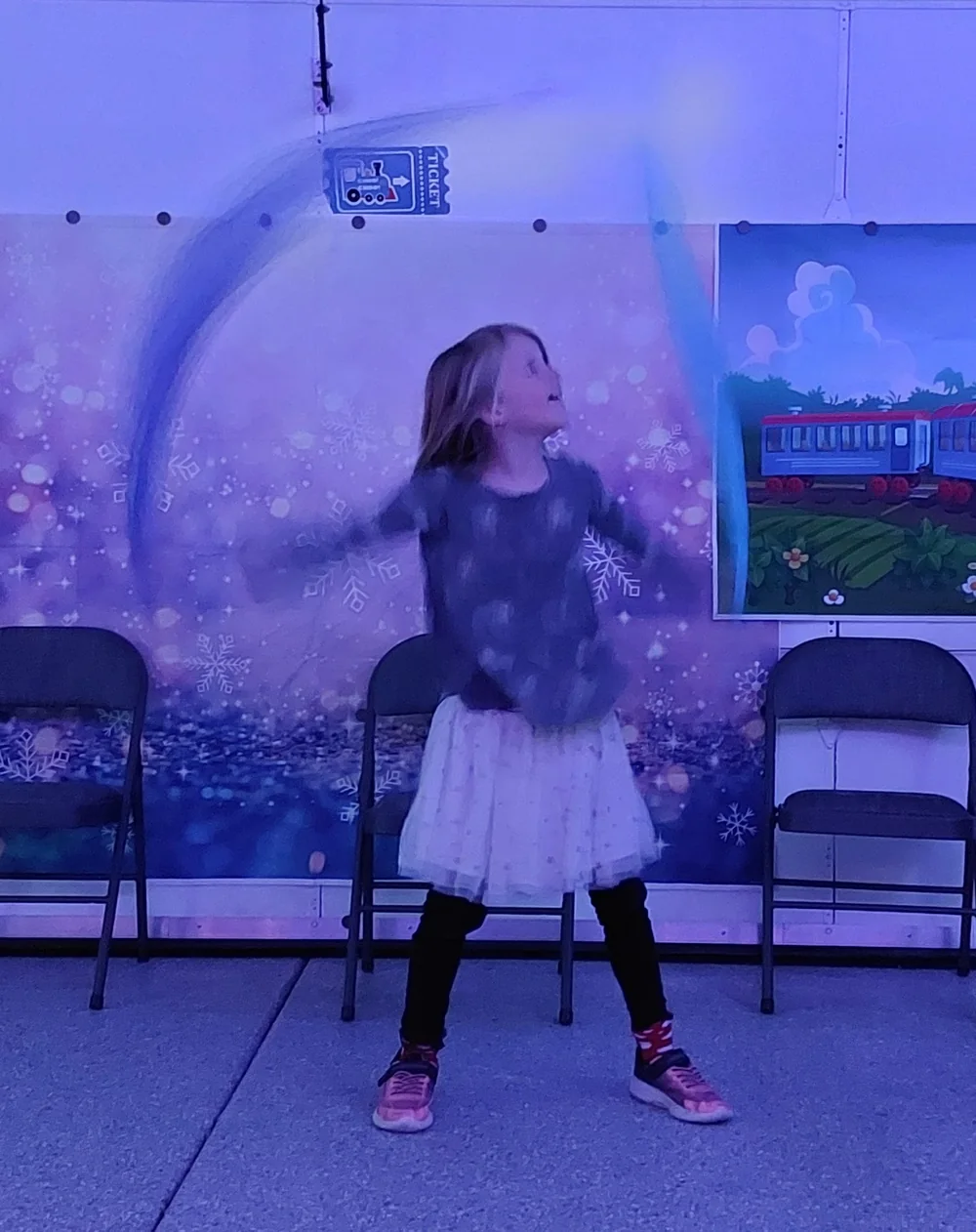 A child moving to the music in class