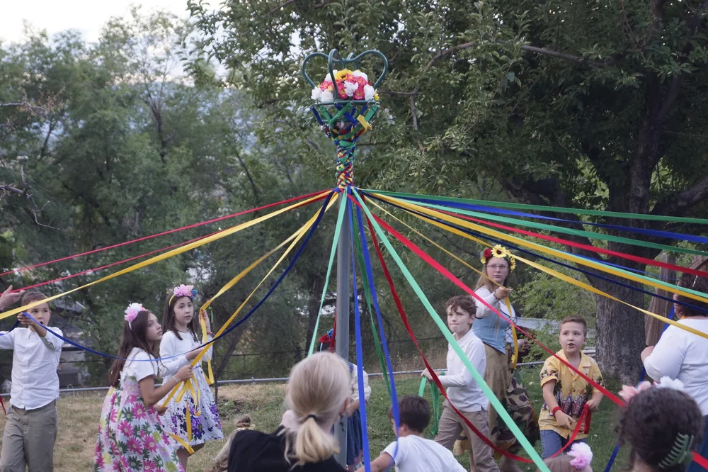 Families dancing around the maypole