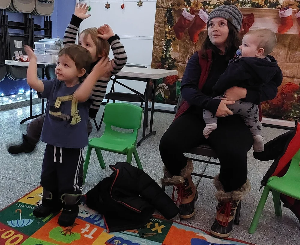 Children and grown-ups playing hand percussion together