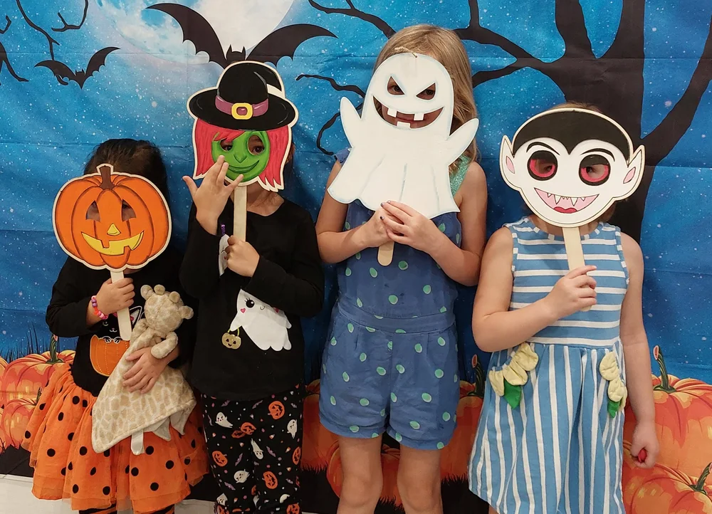 Children holding storytelling puppets in Sing Me a Story