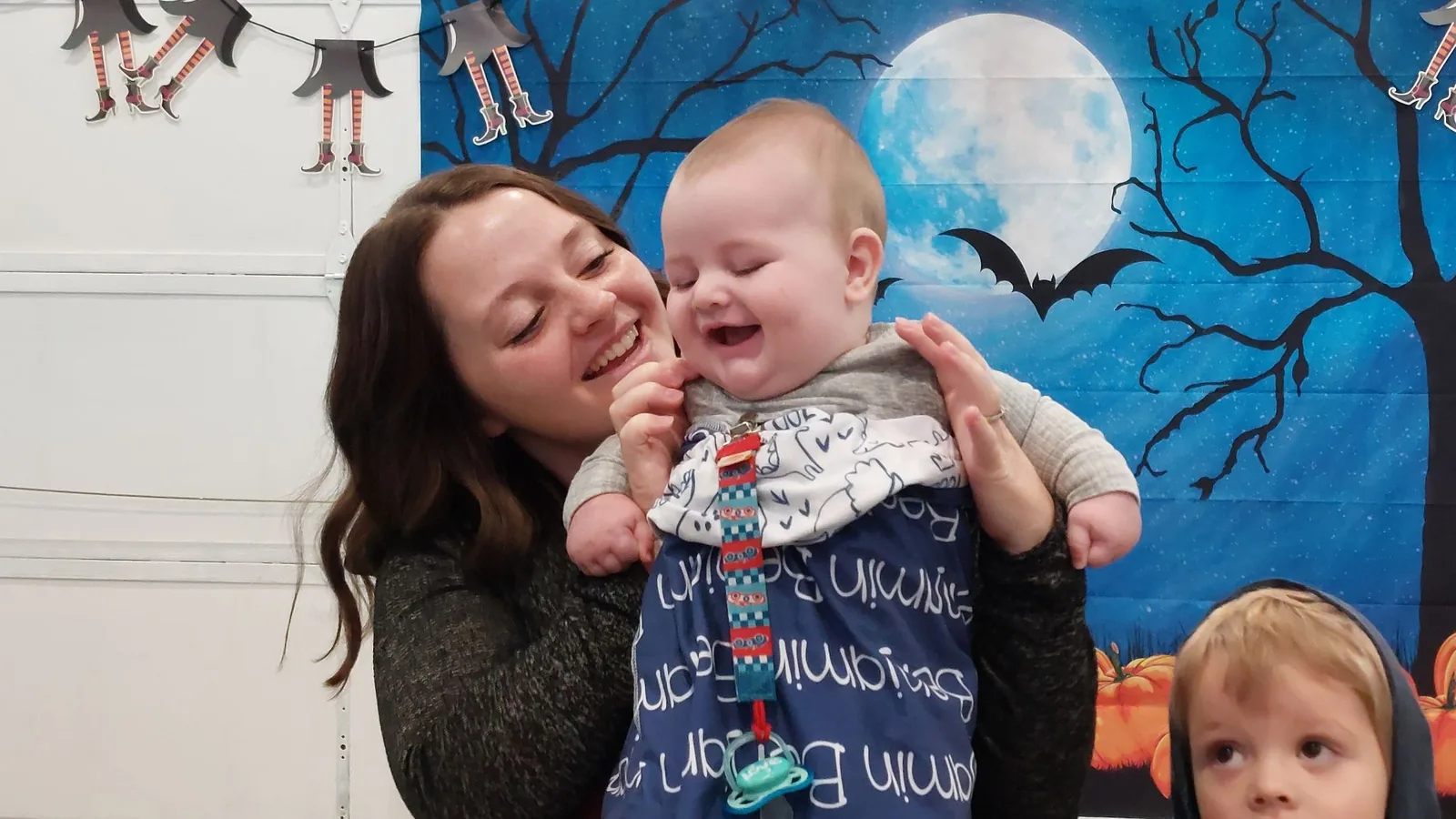 A mother laughing with her baby at a music class